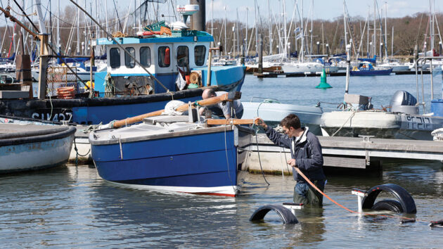 A man recovering a boat from the water