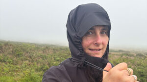 A woman wearing a waterproof in foggy weather