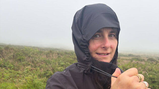 A woman wearing a waterproof in foggy weather