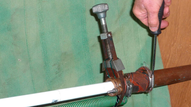 A filter wrench being used to fix a boat stuffing box