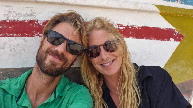 A couple smiling at the camera