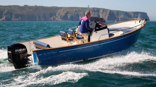 A man driving a power boat off the coast