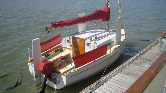 A Red Fox 200 trailer-sailer moored by a pontoon
