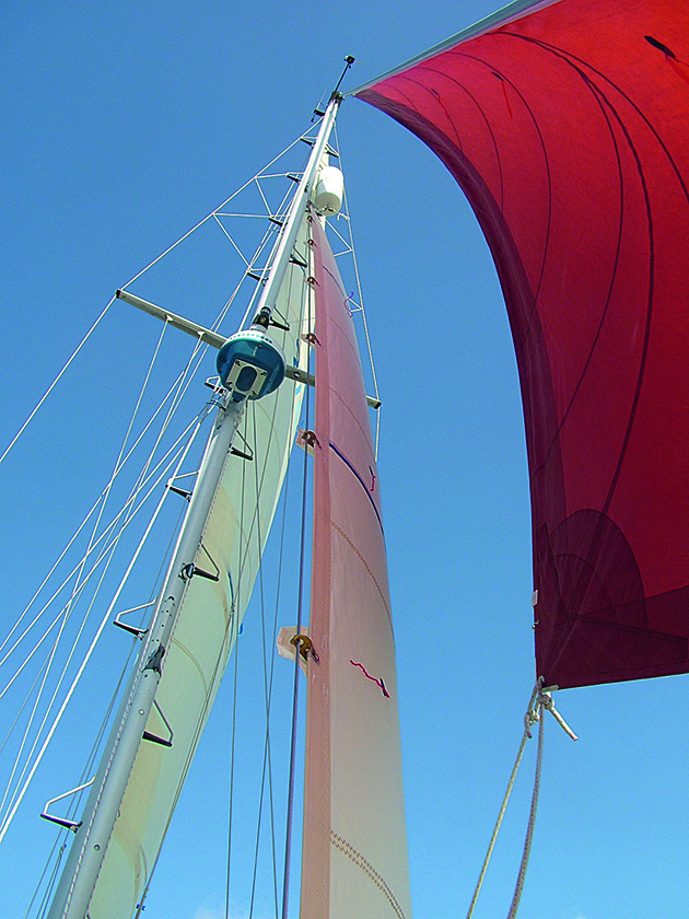 A mast and sails on a yacht