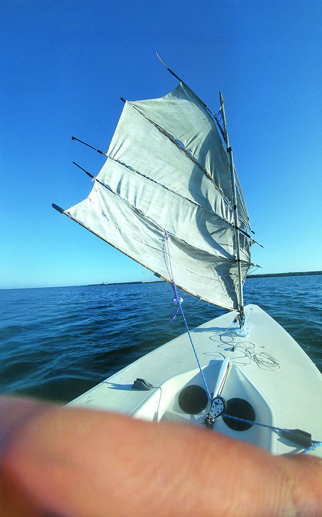 A man selling a laser dinghy with DIY sails