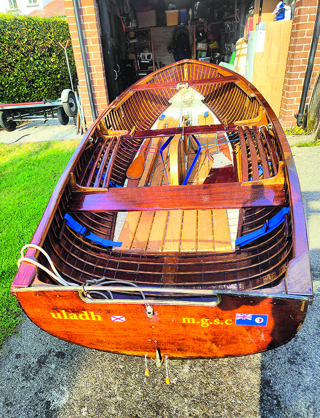 A wooden and restored International 14 dinghy