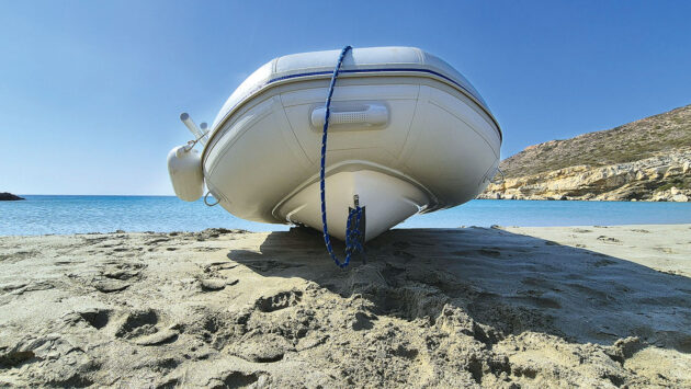 A PVC dinghy on a sandy beach