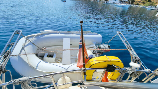 A PVC dinghy suspended off the back of a yacht