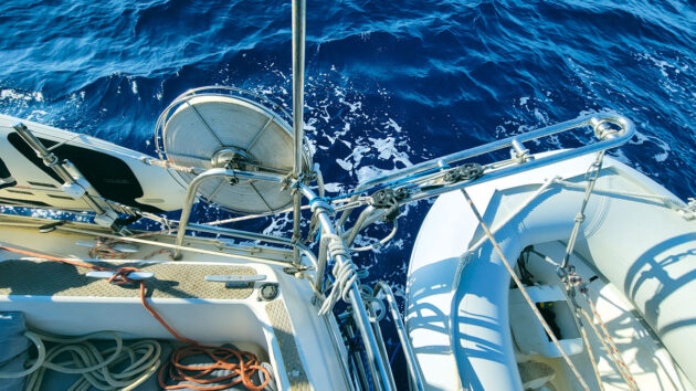 A PVC dinghy suspended from the back of a yacht
