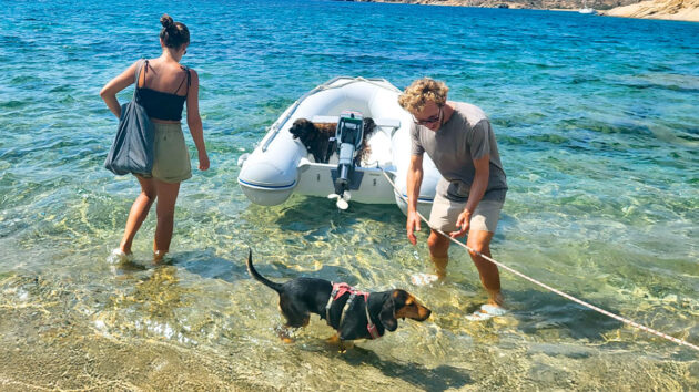 Two people about to get into a PVC dinghy