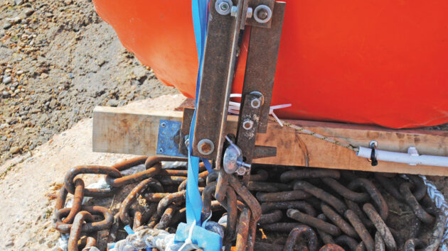 A release mechanism on an air bag and ground tackle for a mooring for a boat