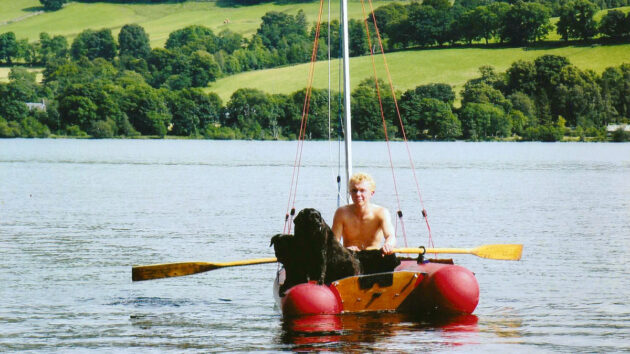 A teenager rowing an inflatable dinghy