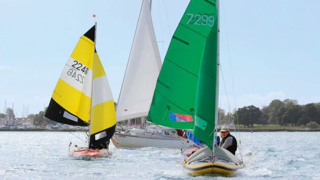 People sailing Tinker dinghies under sail