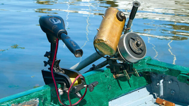 A Seagull outboard engine and an electric engine on the back of a boat