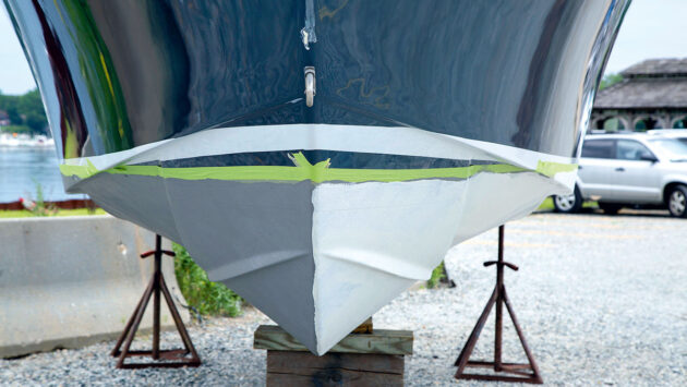 A boat's hull masked off ready for painting