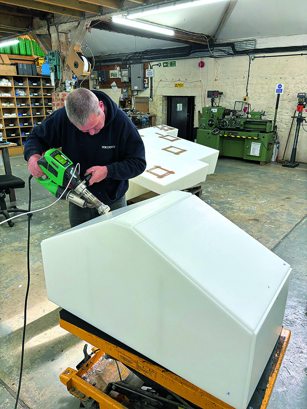 A man making a custom-made boat holding tank