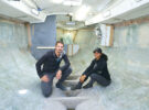 Two people working on their boat to make it a fully electric sailboat
