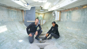 Two people working on their boat to make it a fully electric sailboat