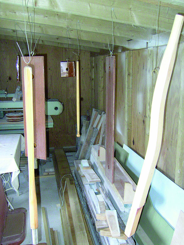 Varnished wood hanging from hooks drying