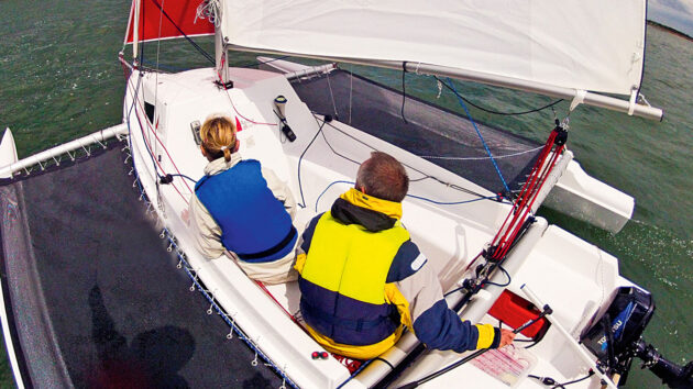 Two people sailing an Astus 20.2 trimaran