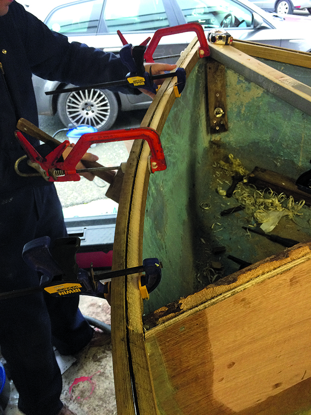 A man making dinghy repairs