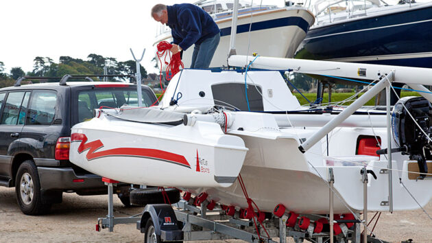 A man rigging an Astus 20.2 trimaran