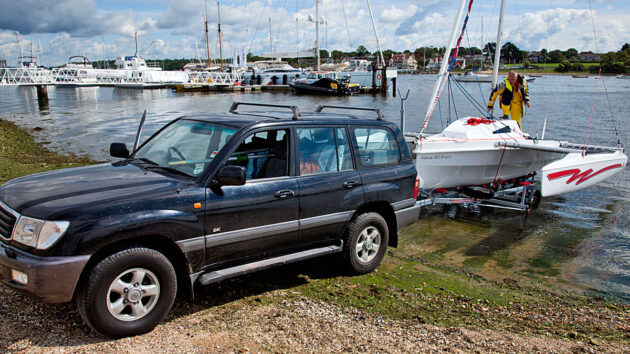 An Astus 20.2 trimaran being launched from a slipway