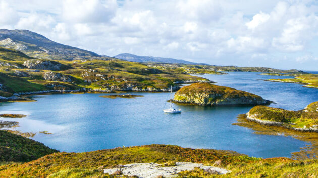 A yacht anchored in a bay in Scotland during a UK boating holidays