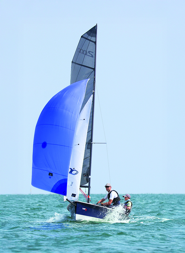 A man and his son sailing a cruising dinghy