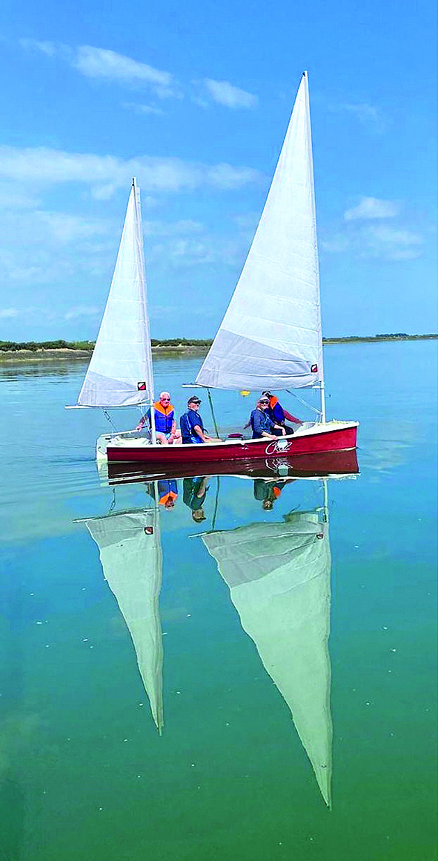 Four people in a Topper Cruz cruising dinghy