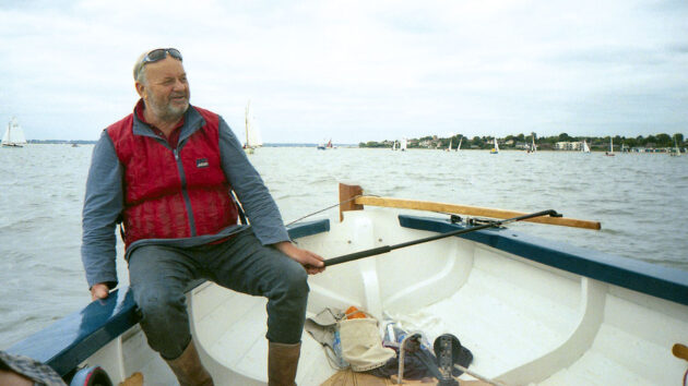 A man sailing a bumpkin boat