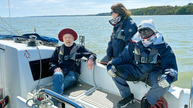 Sir Robin Knox-Johnston talking to crew on a yacht