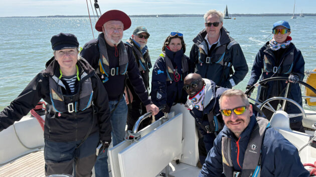 Sir Robin Knox-Johnston with crew on a boat