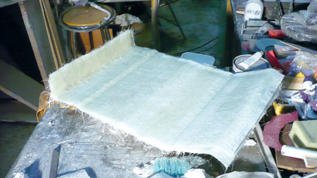 Chopped strand mat being used for boat construction