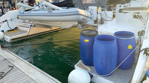 Barrels being put on the hull of a catamaran to allow a hull damaged by a UFO to dry out
