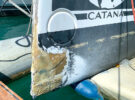 The hull of a catamaran that has been damaged after hitting a UFO at sea