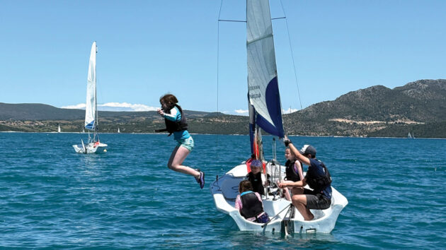 The dinghy sailing lesson finale – girl jumping into the sea, Seafarer Beach Club holiday in Nikiana, Greece