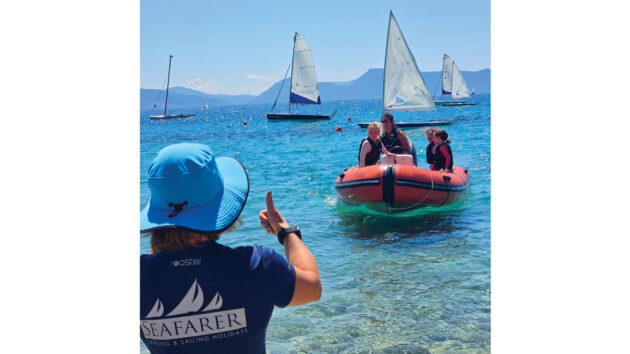 Seafarer Beach Club manager Michelle wisely waits for the safety boat to get within depth before assisting
