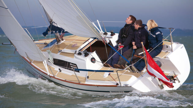 People sitting in the cockpit of the Sunbeam 24.2 yacht