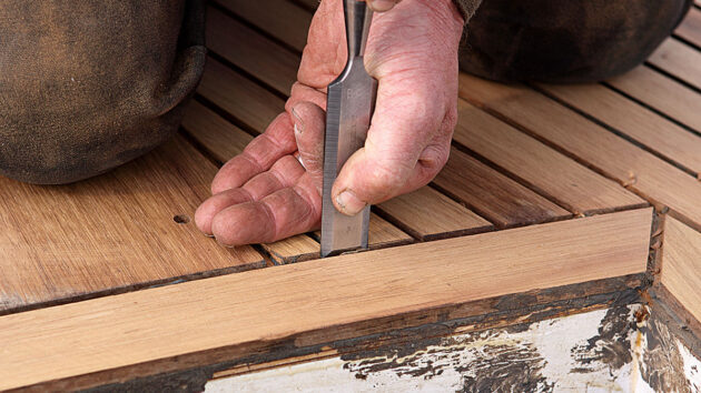 A chisel being used on a boat