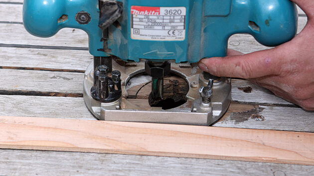 A router being used to a hole in a teak deck