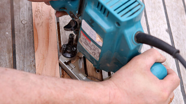 A man using a router on a boat