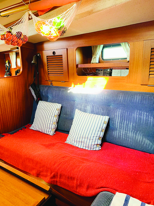 Fruit being stored in nets in the saloon of a liveaboard yacht