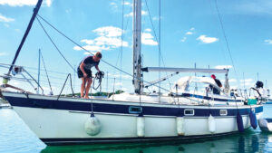 A man moving a fender on a boat