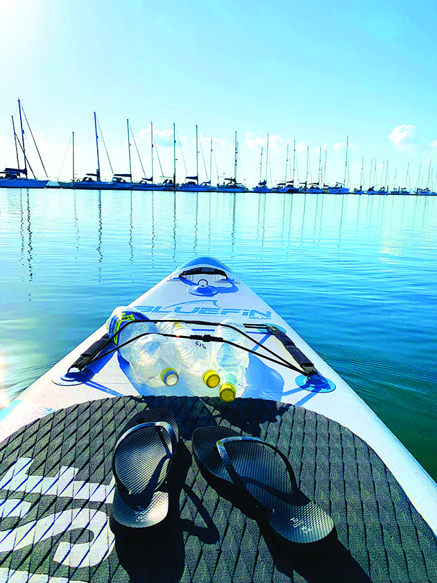 Bottles of water strapped to a stand-up paddleboard