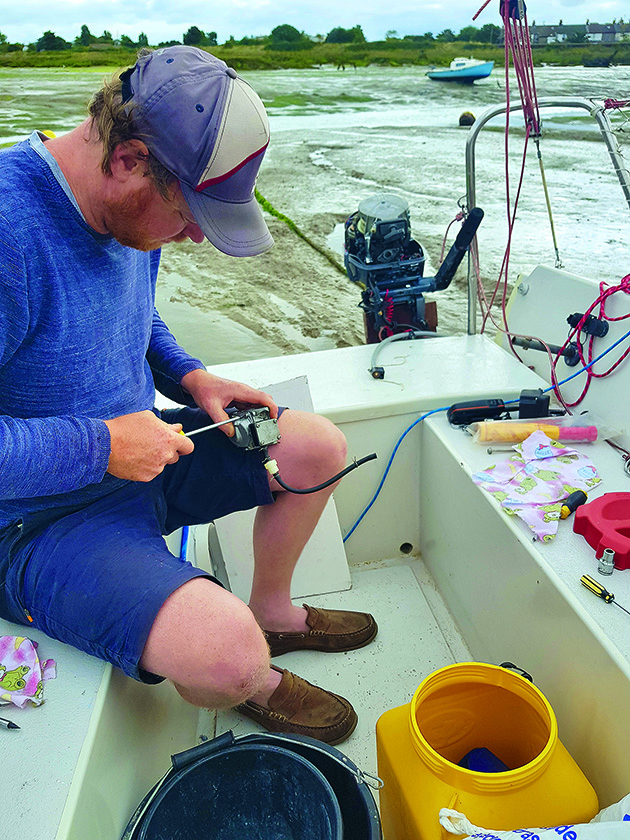 Sailor Ollie Boyes fixing his boat