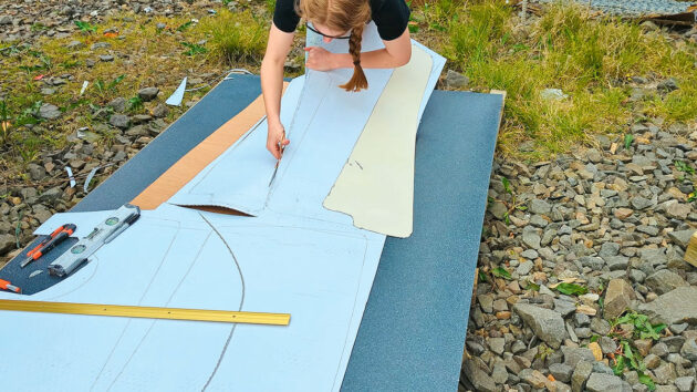 A woman cutting material with a pair of scissors