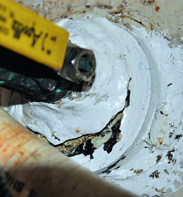 Caulk cracked around a seacock which needs repairs