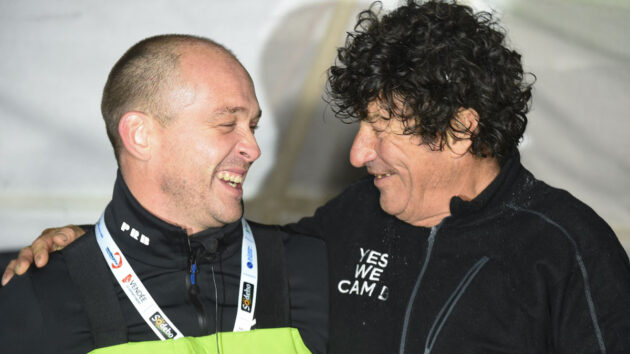 Kevin Escoffier (L) joins French skipper Jean Le Cam (R) who is celebrating after crossing the finish line of the Vendee Globe round-the-world solo sailing race, at Les Sables-d'Olonne, western France, on January 29, 2021. Jean Le Cam who sailed the Imoca 60 monohull "Yes We Cam!", finished in eighth position. Jean Le Cam, dean of the race, came fourth after deduction of the compensation obtained for the rescue of Kevin Escoffier, after the sinking of his boat (Photo by JEAN-FRANCOIS MONIER / AFP) (Photo by JEAN-FRANCOIS MONIER/AFP via Getty Images)