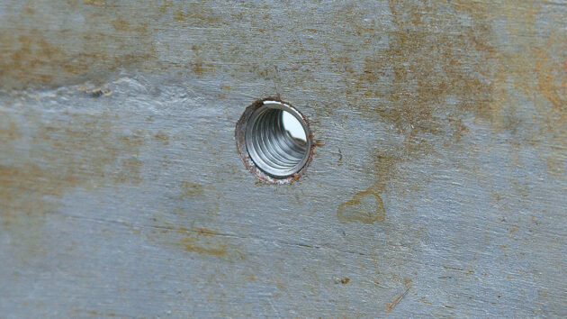 A helicoil being rethreaded into keel bolt holes